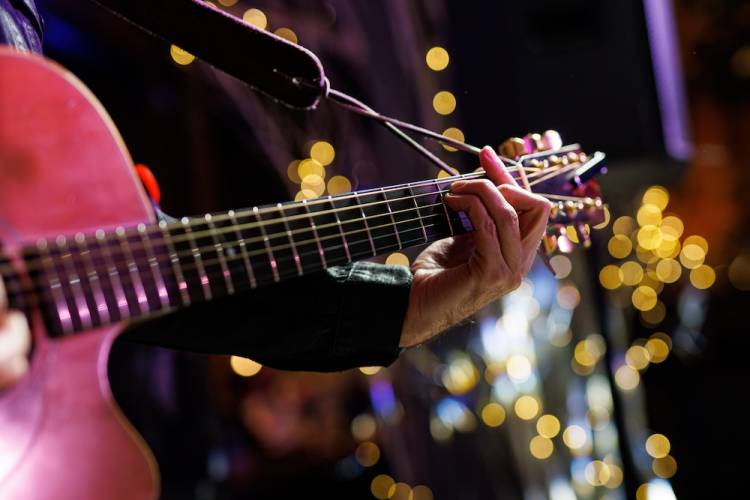 person playing guitar on stage